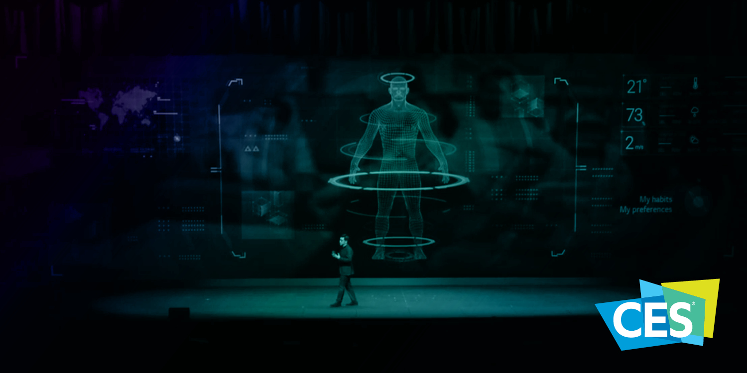 A dark stage with a person presenting in front of a futuristic green holographic display at a tech event, with the CES logo in the foreground.